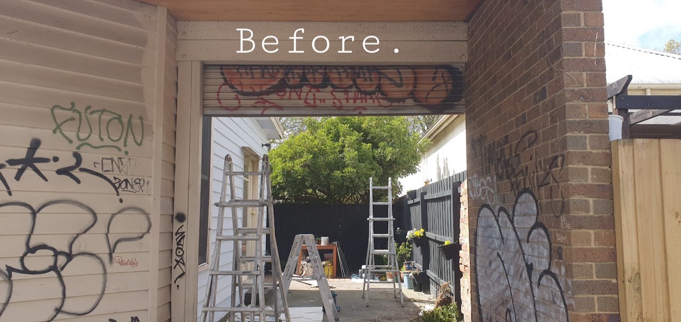 The carport before, tagged with graffiti