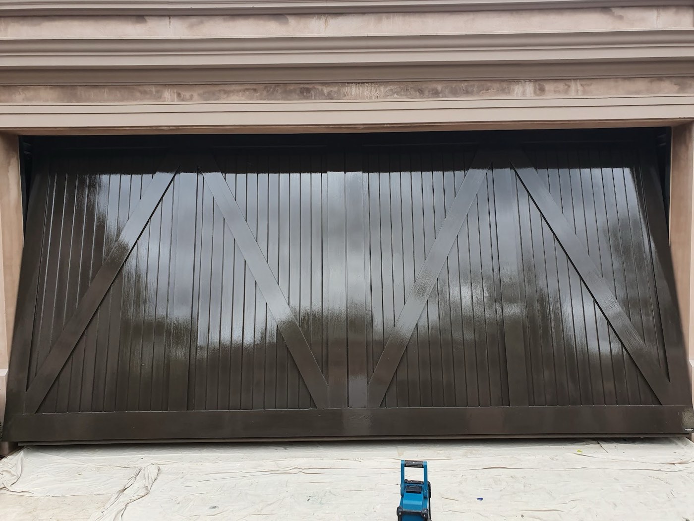 A timber garage door refinished to a deep gloss by A.P.S