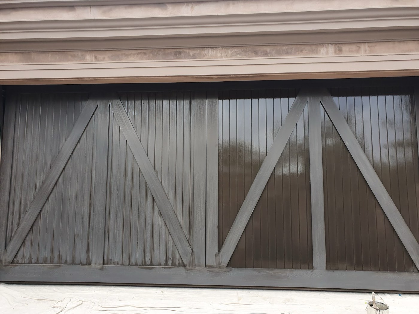 The timber garage door before, dull and weathered
