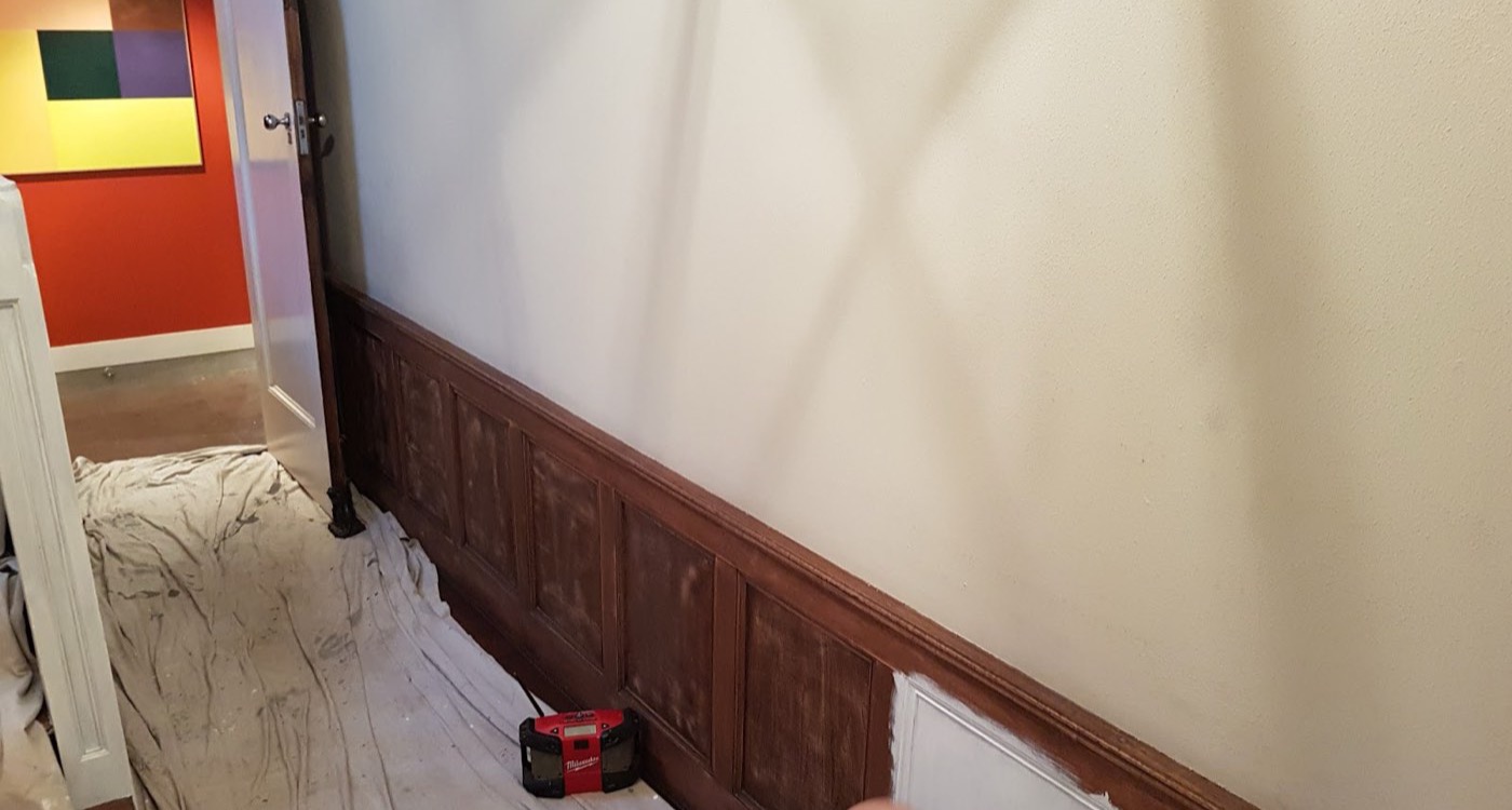 A hallway mid-job with drop sheets down over the floor