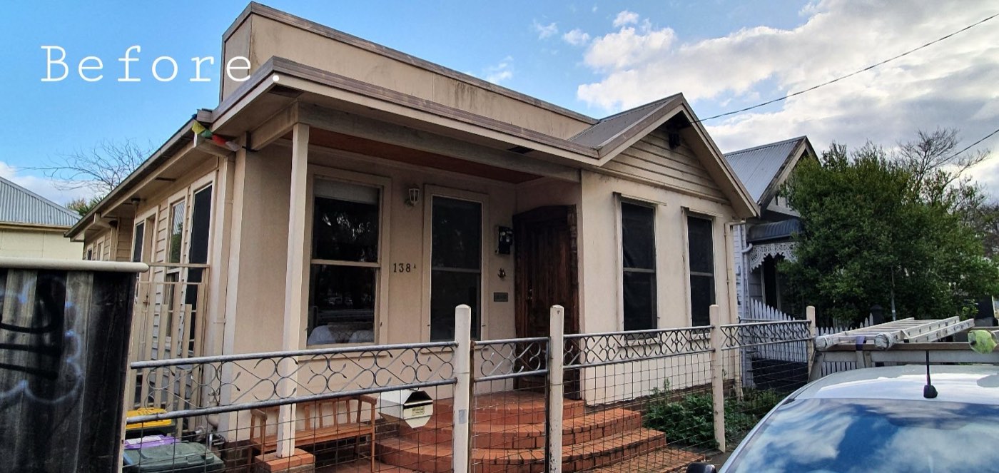 A weatherboard cottage before painting, with faded boards