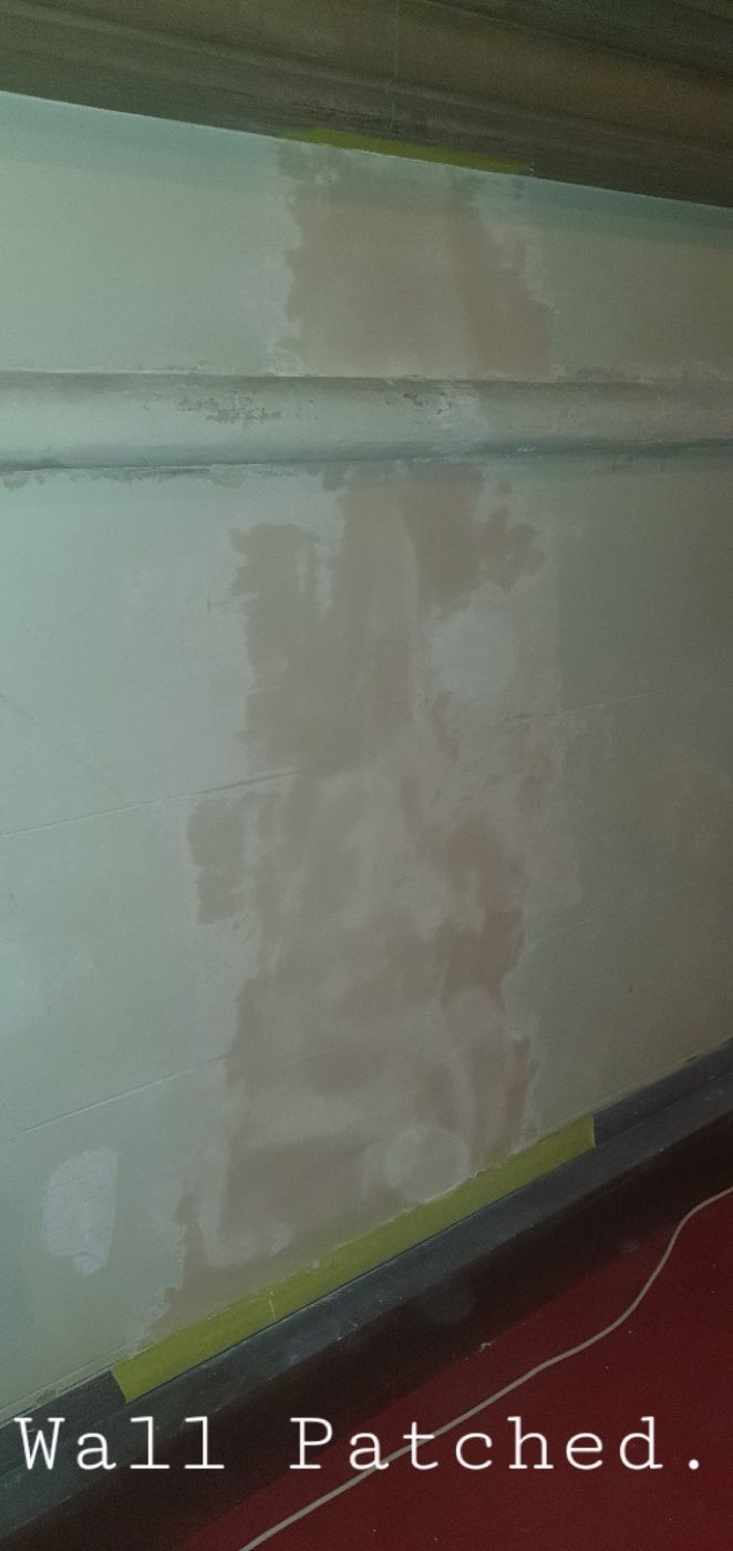 A patched wall, sanded and ready for paint