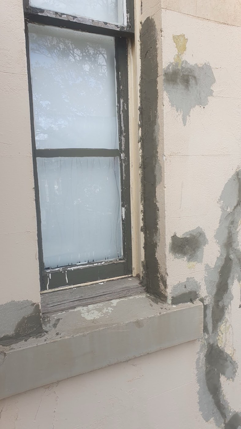 Patched render around a window, ready for painting
